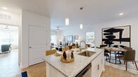 Located at 3450 S Blairstone Rd in Tallahassee, FL, this single-story 2-bedroom, 2-bathroom residence offers a thoughtfully designed open-concept floor plan. The combined living, dining, and kitchen area serves as the heart of the home, featuring warm wood-look flooring, elevated ceilings, and abundant natural light throughout. The kitchen is equipped with stainless steel appliances, white shaker cabinetry, a subway tile backsplash, and a granite-topped island with pendant lighting — ideal for both cooking and casual dining. A dedicated dining nook provides additional space for formal meals. The spacious primary bedroom receives generous natural light through large windows and features a walk-in closet with built-in shelving. Both bathrooms include granite vanity countertops, white cabinetry, and tub-shower combinations with built-in shelving. A dedicated laundry room houses a full-size washer and dryer. Additional highlights include a pantry with open shelving, four closets offering ample storage, and a private patio. The clean, neutral palette and consistent flooring throughout create a cohesive and welcoming ambiance across the entire residence.