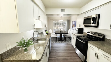 Large, full-featured kitchen with white modern cabinetry - Foxpointe Townhomes