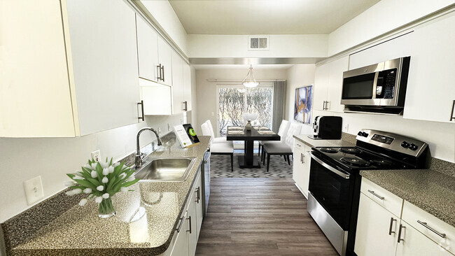 Large, full-featured kitchen with white modern cabinetry - Foxpointe Townhomes