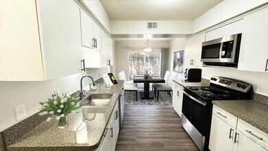 Large, full-featured kitchen with white modern cabinetry - Foxpointe Townhomes