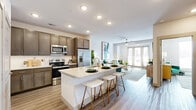 Located in Franklin, TN, this thoughtfully designed one-bedroom, one-bathroom residence offers a cohesive open-concept layout with light wood-style flooring throughout. The living room provides a bright, welcoming atmosphere, highlighted by large windows with exterior views and a versatile nook that accommodates both a workspace and dining area. Glass patio doors flood the space with natural light and offer direct outdoor access.

The kitchen is a standout feature, equipped with rich dark cabinetry, stainless steel appliances, a subway tile backsplash, and a generous granite-topped island with seating for multiple guests — ideal for casual dining and entertaining. Recessed lighting overhead adds a clean, polished feel.

The bedroom is a comfortable retreat, featuring a ceiling fan, ample natural light from multiple windows, and access to a well-organized walk-in closet with built-in shelving and hanging space. The full bathroom connects directly to the bedroom and includes a granite-topped dual vanity with dark cabinetry, a soaking tub, and a separate tiled shower. Neutral tones and clean finishes throughout create a cohesive, modern aesthetic, making this residence a functional and stylish home in the heart of Franklin.