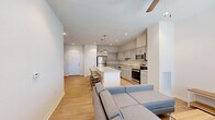 Located in Pullman, WA, this two-story residence offers four bedrooms and five bathrooms across two well-proportioned floors. The main level centers on an open-concept living and kitchen area, where light hardwood-style flooring flows throughout. The kitchen is outfitted with stainless steel appliances, including a refrigerator, range, microwave, and dishwasher, complemented by gray shaker-style cabinetry and granite countertops. A large central island with seating for multiple bar stools serves as both a prep space and casual dining area, illuminated by pendant lighting above. The adjoining living room receives generous natural light through large windows fitted with horizontal blinds, and includes a ceiling fan overhead.

The bathrooms feature consistent finishes throughout, including granite-topped vanities with gray cabinetry, tub-shower combinations, and wood-look flooring. Bedrooms are carpeted and include ceiling fans, with windows providing natural light and views of the surroundings. Each bedroom offers functional space suitable for a bed, desk, and storage. Two hallways and two closets contribute to the overall functionality of the layout, ensuring practical circulation across both floors.