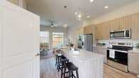 Located at 3401 N Elm Ave in Broken Arrow, Oklahoma, this thoughtfully designed single-story home offers three bedrooms and three bathrooms across a well-utilized floor plan. Light wood-look flooring flows seamlessly throughout, creating a cohesive and airy atmosphere.

The open-concept kitchen is a standout feature, boasting a central island with seating, light wood shaker cabinetry extending to the ceiling, granite-look countertops, and a full suite of stainless steel appliances, including a refrigerator with ice maker, electric range, and over-the-range microwave. Recessed and pendant lighting add a refined touch.

The adjoining living room is bright and welcoming, with tall ceilings, a ceiling fan, large windows, and sliding glass doors that open directly to an outdoor patio — bringing in abundant natural light and easy indoor-outdoor flow. A separate living room area provides additional flexible space.

Each bedroom features neutral tones and window treatments that allow for natural light, while the primary bedroom offers a comfortable, well-proportioned retreat. The three bathrooms are clean and functional, with tub/shower combinations and wood-look flooring. Hallways connect the spaces efficiently, and dedicated closets provide practical storage throughout this well-appointed home.