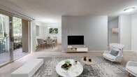 This 760 square foot apartment offers a thoughtfully designed living space with one bedroom and one bathroom. The open-concept layout maximizes the available area, creating a sense of spaciousness throughout. The living room is the heart of the home, featuring a large sliding glass door that floods the space with natural light and provides access to an outdoor area. A contemporary gray sofa, sleek coffee table, and carefully curated artwork contribute to the modern aesthetic.

The kitchen, while compact, is efficiently designed with white cabinetry, light-colored countertops, and full-sized appliances. Wood-look flooring adds warmth to the space. The bedroom, measuring 180 square feet, offers ample room for a queen-sized bed and includes a built-in closet for storage. The bathroom showcases a clean, minimalist design with a white vanity and a shower/tub combination.

Throughout the apartment, neutral tones dominate, creating a calm and cohesive atmosphere. The strategic placement of windows in various rooms ensures good natural lighting. Textured carpeting in the living areas and bedroom adds comfort underfoot. This well-planned apartment combines style and functionality, making efficient use of every square foot to provide a comfortable living space.