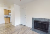 This 620-square-foot, single-story apartment at 2601 E McKellips Rd in Mesa, AZ offers a practical and comfortable layout across two bedrooms and two bathrooms. The living room serves as the heart of the unit, featuring wood-style plank flooring, a ceiling fan, a tiled fireplace, and a sliding glass door that opens to a private balcony with outdoor views. The galley-style kitchen is efficiently designed with warm oak cabinetry, dark granite-style countertops, a white appliance suite including a range and refrigerator, and wood-style flooring throughout. Both bedrooms are carpeted and equipped with ceiling fans, offering a cozy atmosphere. The primary bedroom measures 120 square feet and includes closet storage, while the second bedroom also features a built-in closet. The two bathrooms are finished with oak vanity cabinetry, dark countertops, large mirrors, and wood-style tile flooring. One bathroom includes a full tub-shower combination. A hallway and dedicated closet space add to the unit's functionality. Neutral wall tones throughout the apartment create a clean, move-in-ready aesthetic well-suited for Mesa's warm climate.