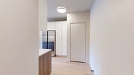 Located at 1706 Sherman Ave in Evanston, IL, this thoughtfully designed 2-bedroom, 2-bathroom residence seamlessly merges industrial heritage with modern aesthetics. Exposed yellow brick walls serve as a defining architectural feature throughout, complemented by light hardwood flooring and crisp white walls that create a bright, cohesive atmosphere.

The kitchen is a standout, outfitted with flat-front cabinetry in white and warm wood tones, a textured tile backsplash with under-cabinet lighting, stainless steel appliances including a side-by-side refrigerator and range, and a sleek quartz countertop with a matte black faucet. The open sightline from the kitchen toward the living area highlights the dramatic exposed brick and large black-framed windows that flood the space with natural light.

The primary bedroom features soaring ceilings, floor-to-ceiling sliding glass doors opening to a private balcony, and expansive exposed brick—lending the room a loft-like, open character. The second bedroom is equally well-appointed, with large black-framed windows offering neighborhood views alongside its own exposed brick accent wall.

Both bathrooms are finished to a high standard. One features vertical sage green tile in a glass-enclosed shower with matte black fixtures and a floating wood-toned vanity. The second bath showcases glossy stacked tile, a floating charcoal vanity, and a glass shower enclosure with globe lighting above the mirror.