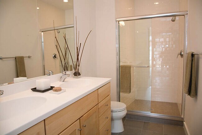 En-suite bathroom with modern finishes, plenty of counter space, and a large shower - 1123 6th St NW