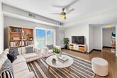 This contemporary apartment in Ankeny, Iowa, maximizes its 1240 square feet with a thoughtful layout. The space boasts three bedrooms, including a primary bedroom of 160 square feet, and an impressive five bathrooms, ensuring comfort and privacy for residents and guests alike.

Throughout the apartment, wood-style flooring creates a warm, cohesive look. Large windows in the bedrooms and living areas flood the space with natural light, enhancing the open feel. The living room features a ceiling fan and sliding glass doors leading to an outdoor area, perfect for relaxation or entertaining.

The kitchen is a highlight, equipped with stainless steel appliances and rich, dark wood cabinetry that contrasts beautifully with light countertops. Ample storage space is provided by both upper and lower cabinets.

Bathrooms are designed with functionality in mind, featuring clean lines and modern fixtures. At least one bathroom includes a combination tub-shower unit.

The apartment's single-floor layout promotes easy accessibility, while multiple closets offer plenty of storage options. The neutral color palette throughout provides a blank canvas for personal decorating styles.

This well-designed space strikes a balance between comfort and style, making it an ideal home for those seeking modern urban living in Ankeny.