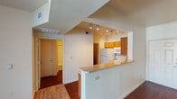 Located at 9901 Bruton Rd in Dallas, Texas, this single-floor unit offers a practical and functional layout designed for comfortable living. The living area features wood-look flooring and is illuminated by track lighting, creating a bright and open atmosphere. It flows seamlessly into the kitchen, which is separated by a breakfast bar with a laminate countertop — ideal for casual dining or meal prep. The kitchen is well-equipped with warm oak cabinetry, a coil-burner electric range, an over-the-range microwave, a refrigerator, and ample counter space.

The unit includes multiple bedrooms, each finished with neutral carpet and ceiling fans with light fixtures. One bedroom features a sliding glass door with vertical blinds, offering access to an outdoor area and allowing natural light to fill the room. The bedrooms are served by two full bathrooms, both featuring wood-look flooring, oak vanity cabinetry, and tub-shower combinations. One bathroom includes a well-lit vanity mirror with overhead lighting. A textured ceiling throughout the main living and kitchen areas adds a classic touch, while the overall neutral color palette provides a clean, move-in-ready canvas.