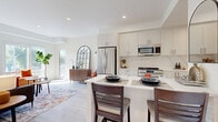 Located at 1370 Stittsville Main St in Ottawa, this thoughtfully designed one-bedroom, one-bathroom unit offers a smart and efficient single-floor layout with modern finishes throughout. The open-concept kitchen and living area forms the heart of the space, where crisp white cabinetry, marble-look quartz countertops, and a full suite of stainless steel appliances — including a French door refrigerator, range, and over-the-range microwave — create a sleek, functional cooking space. A two-seat breakfast bar provides a casual dining option that flows naturally into the living area. The living room is bright and airy, benefiting from large windows and a sliding door that invite generous natural light and outdoor views of the surrounding Stittsville neighbourhood. Light-toned hardwood-style flooring runs throughout, adding warmth and continuity. The bedroom is a comfortable retreat featuring a large window with neighbourhood views, a closet with modern hardware, and a calm, neutral palette. The bathroom impresses with floor-to-ceiling marble-look tile, a glass-enclosed walk-in shower, and clean contemporary fixtures. A hallway connects all rooms efficiently, completing this well-appointed urban unit.