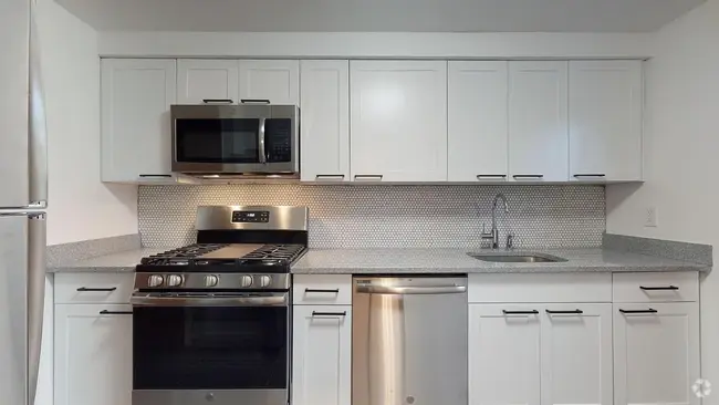 Completely renovated kitchen with modern stainless steel appliances, and quartz countertops - 31 Marylea Ave