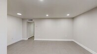 Located at 13890 NE 3rd Ct in North Miami, FL, this one-bedroom, two-bathroom unit offers a clean, modern layout designed for comfortable everyday living. Large-format neutral tile flooring runs consistently throughout the space, lending a cohesive and easy-to-maintain aesthetic.

The kitchen is well-appointed with crisp white cabinetry, a mosaic tile backsplash, recessed lighting, and full-size appliances including a refrigerator and range. The open, light-filled living area features recessed ceiling lights and a window that brings in natural light.

The spacious primary bedroom comfortably accommodates a full furniture arrangement and is equipped with a ceiling fan with integrated lighting, a wide window overlooking lush greenery, and two sets of louvered bifold closet doors providing ample storage.

The two bathrooms are finished in a clean, modern style. One features a floating white vanity with a white quartz countertop, an LED-backlit mirror, and direct hallway access to the kitchen. The second bathroom includes a full tub-shower combination surrounded by classic white subway tile and a privacy window.

A connecting hallway ties all rooms together efficiently, creating a practical and well-organized floor plan ideal for single occupants or couples in the heart of North Miami.
