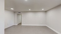Located at 13890 NE 3rd Ct in North Miami, FL, this one-bedroom, two-bathroom unit offers a clean, modern layout designed for comfortable everyday living. Large-format neutral tile flooring runs consistently throughout the space, lending a cohesive and easy-to-maintain aesthetic.

The kitchen is well-appointed with crisp white cabinetry, a mosaic tile backsplash, recessed lighting, and full-size appliances including a refrigerator and range. The open, light-filled living area features recessed ceiling lights and a window that brings in natural light.

The spacious primary bedroom comfortably accommodates a full furniture arrangement and is equipped with a ceiling fan with integrated lighting, a wide window overlooking lush greenery, and two sets of louvered bifold closet doors providing ample storage.

The two bathrooms are finished in a clean, modern style. One features a floating white vanity with a white quartz countertop, an LED-backlit mirror, and direct hallway access to the kitchen. The second bathroom includes a full tub-shower combination surrounded by classic white subway tile and a privacy window.

A connecting hallway ties all rooms together efficiently, creating a practical and well-organized floor plan ideal for single occupants or couples in the heart of North Miami.