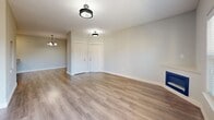 Located in Gladstone, Oregon, this well-appointed 3-bedroom, 2-bathroom single-floor residence offers a comfortable and functional layout. The open living room is bright and inviting, featuring durable wood-style flooring, a sleek built-in fireplace, and sliding glass doors that lead to a private balcony overlooking the surrounding community and towering trees under open skies. The kitchen is thoughtfully designed with warm wood cabinetry, granite-style countertops, a peninsula with an undermount sink, and a full suite of stainless steel appliances including a refrigerator, range, microwave, and dishwasher. The generously sized primary bedroom provides ample closet space, while the additional bedrooms feature plush carpeting, ceiling fans, natural light from windows, and double closets. The primary bathroom offers a dual-sink vanity with granite countertops, warm wood cabinetry, a large mirror, and a tub-shower combination. A second full bathroom includes a clean tub-shower unit. A connecting hallway ties the layout together efficiently. Neutral tones and clean finishes throughout create a move-in ready environment suitable for a variety of lifestyles.