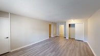 Located at 741 Barcelona Ct in Birmingham, Alabama, this single-floor residence offers a well-organized layout with a neutral, clean aesthetic throughout. The expansive main living area is finished with light-toned wood-look flooring, crisp white baseboards, and a textured ceiling, creating a bright and open atmosphere. Multiple doorways lead seamlessly to other areas of the home, reinforcing the functional flow of the floor plan. The kitchen is thoughtfully appointed with white shaker-style cabinetry, stainless steel appliances including a refrigerator and dishwasher, a stainless steel sink, and light speckled countertops — all set atop matching wood-look flooring. The bedrooms feature soft wall-to-wall carpeting and natural light courtesy of window blinds, lending a comfortable and cozy feel. Two bathrooms serve the home: one features a walk-in shower with grab bars, built-in shelving, and wood-look flooring, while the other offers a shower-tub combination, a wide vanity with speckled countertops, a large mirror, and ample cabinetry. The consistent use of neutral tones, updated fixtures, and cohesive flooring choices throughout the home contributes to a clean, move-in-ready environment well-suited for comfortable everyday living.