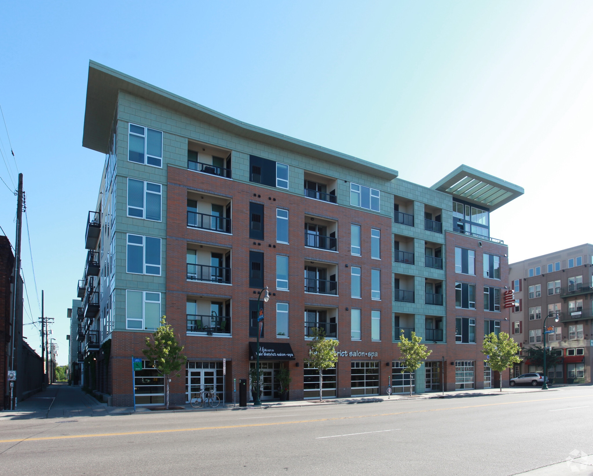 Exterior view of a modern brick apartment building with large windows and balconies.