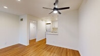 Located in the West Hills neighborhood of Los Angeles, this single-story 3-bedroom, 2-bathroom home offers a clean, modern aesthetic throughout. Warm wood-look flooring runs continuously across the living spaces, complemented by crisp white walls and recessed lighting that create a bright, welcoming atmosphere.

The open living room receives generous natural light through a large sliding glass door and features a ceiling fan with integrated lighting. It flows seamlessly toward the kitchen, which is outfitted with white shaker cabinetry, quartz countertops, stainless steel appliances including a refrigerator and dishwasher, and a peninsula that provides additional workspace. A stacked washer and dryer unit is conveniently housed within the kitchen area.

Each of the three bedrooms includes a ceiling fan and wood-look flooring. The primary bedroom features full mirrored sliding closet doors that enhance the sense of space, along with a window that brings in natural light. The additional bedrooms are similarly finished, with one offering a bright corner window with neighborhood views.

Both bathrooms are finished in a clean, all-white palette and each features a shower/tub combination enclosed by sliding glass doors. Hallways connect the rooms efficiently, contributing to a well-organized and functional floor plan throughout the home.