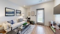 Located at 950 Professional Pkwy in Marysville, Ohio, this thoughtfully designed 3-bedroom, 2-bathroom unit offers a clean, modern aesthetic across a single floor. The open-concept kitchen serves as the centerpiece, featuring striking granite countertop island with an undermount sink, white shaker cabinetry, stainless steel appliances, and geometric pendant lighting that adds a contemporary flair. Wood-look flooring flows seamlessly through the kitchen and living areas, creating a cohesive, warm atmosphere.

The living room is bright and welcoming, with natural light streaming through a glass-panel exterior door fitted with white blinds. The space easily accommodates a full seating arrangement and workspace area. Each bedroom offers carpeted flooring and well-proportioned layouts, with windows providing outdoor views and ample natural light. The primary bedroom features a dedicated walk-in closet equipped with wire shelving systems for organized storage.

Both bathrooms are finished with granite-topped white vanities and wood-look flooring. The primary bath includes a walk-in glass-door shower, while the secondary bath offers a clean, functional design. Neutral white walls throughout the unit create a bright, airy ambiance that complements the modern finishes and makes the space feel open and inviting.