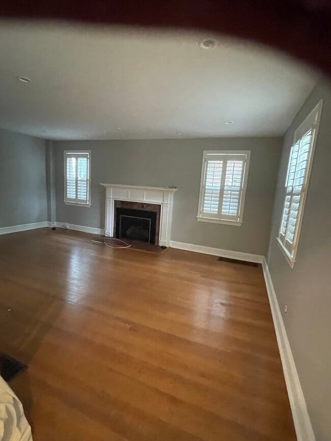 Spacious living room with modern gas fireplace freshly painted and refinished - 7819 12th St NW