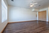 Located at 300 E Main St in Sun Prairie, Wisconsin, this thoughtfully designed unit makes excellent use of its compact footprint across a single floor. The open-concept layout seamlessly combines the living room, dining area, and kitchen into one cohesive, light-filled space. Warm wood-look flooring runs throughout the main living areas, while tile flooring grounds the kitchen and bathrooms. Ceiling fans provide both function and a finishing touch to the living spaces, and windows invite natural light and outdoor views into the home.

The kitchen is equipped with black appliances, including a refrigerator, range, and over-the-range microwave, complemented by light maple cabinetry and a neutral laminate countertop. A peninsula with pendant lighting above offers additional workspace and a casual dining option, while a dedicated pantry provides generous storage.

Two full bathrooms feature tile flooring, light maple vanity cabinetry, stone-tone countertops, and large mirrors. Three closets throughout the unit offer ample storage solutions. A dedicated entrance completes the layout, contributing to a practical and organized flow. Overall, the space presents a clean, modern aesthetic with a warm, welcoming ambiance.