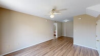 Located at 100 Crestwood Dr in Beebe, Arkansas, this single-floor, one-bedroom, one-bathroom home offers a practical and efficient layout. The living room is a bright, open space featuring wood-look plank flooring, neutral warm-beige walls, and a ceiling fan with light fixture. A sliding glass door allows natural light to fill the room and provides direct outdoor access. The combined dining and kitchen area is well-equipped with white cabinetry trimmed in warm oak, white appliances including a range, refrigerator, and dishwasher, ample counter space, and a sink — all set over matching wood-look flooring. An in-unit washer is also present, adding everyday convenience. The bedroom is a comfortably sized retreat with plush carpeting, a window with blinds that invites natural light, and two closets for generous storage. The bathroom features a full tub-shower combination with white tile surround, a vanity with storage, and wood-look flooring that ties the space together cohesively. A dedicated utility room completes the home. Throughout, the consistent neutral palette and clean finishes create a simple, functional living environment well-suited for comfortable everyday living.