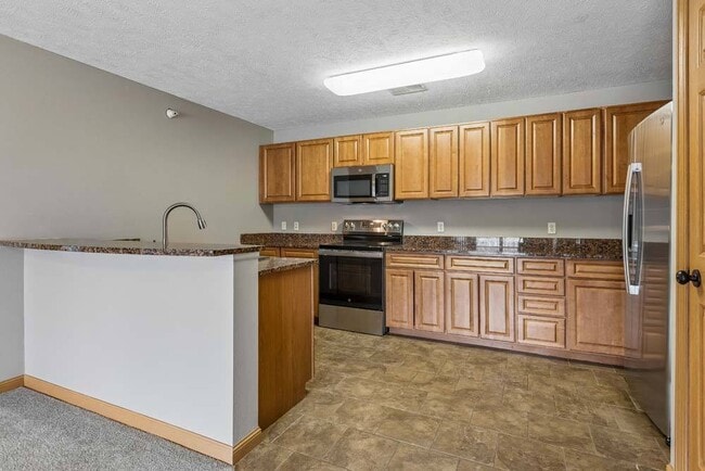 Bring your favorite recipes to life in this spacious kitchen featuring abundant cabinetry and an open design made for easy entertaining. - Grand Legacy