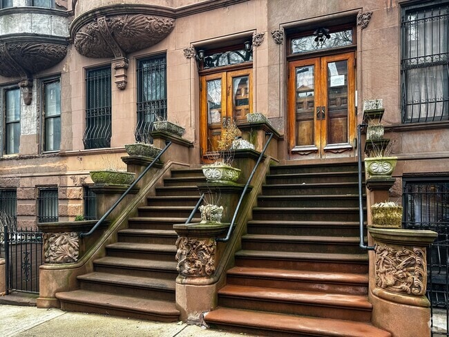 Stairs leading up to a brownstone apartment building in Hamilton Heights.