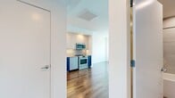 This well-appointed 1-bedroom, 1-bathroom unit at 1300 Fairmount Ave spans 550 square feet of modern living space across a single floor. The open-concept living room and kitchen area is anchored by warm hardwood flooring and bright white walls, creating a clean, contemporary aesthetic throughout. Large windows flood the space with abundant natural light while offering sweeping panoramic city views, giving the unit an elevated, airy feel.

The kitchen is a standout feature, showcasing bold two-tone cabinetry with white upper cabinets and vibrant cobalt blue lower cabinets, complemented by a geometric hexagonal tile backsplash. A full suite of stainless steel appliances — including a refrigerator, range, microwave, and dishwasher — and recessed lighting complete this functional and stylish space.

The bedroom measures 140 square feet and features large windows with expansive city views, a double-door closet, and the same warm hardwood flooring found throughout the unit. The bathroom is finished with floor-to-ceiling hexagonal tile, a soaking tub with a glass shower panel, and modern wood-accented vanity cabinetry, offering a spa-like retreat within the home.