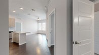 Located at 486 Centerpointe Circle in Altamonte Springs, Florida, this 2-bedroom, 3-bathroom residence offers a clean, modern aesthetic throughout its well-designed single-floor layout. Dark hardwood-style flooring flows consistently across the living areas and bedrooms, complementing the crisp white walls and creating a polished, contemporary look.

The kitchen is a standout feature, equipped with stainless steel appliances — including a French door refrigerator with ice maker, range, microwave, and dishwasher — paired with light wood cabinetry, a subway tile backsplash, and a granite-topped center island that provides both additional prep space and a casual dining option.

The open living room benefits from natural light through wide windows and features a ceiling fan. The generously sized primary bedroom includes direct access to an exterior door, multiple windows with exterior views, and a walk-in closet outfitted with wire shelving systems. The second bedroom is bright and well-proportioned, also featuring natural light and its own walk-in closet.

The bathrooms are finished with granite countertops, gray-toned tile flooring, and modern fixtures, with at least one full bath featuring a tiled tub-shower combination. The overall ambiance is bright, neutral, and move-in ready.