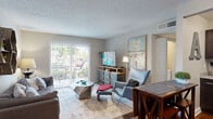 Located at 1145 Ivystone Square in Chesapeake, Virginia, this single-story, 2-bedroom, 2-bathroom residence offers a well-organized layout across a compact yet functional floor plan. The living room serves as the heart of the home, featuring wood-style flooring, a textured ceiling, and a sliding glass door that fills the space with natural light while providing direct access to a private balcony overlooking greenery. The open connection to the dining area creates a seamless flow for everyday living.

The kitchen is outfitted with dark espresso cabinetry, granite-style countertops, stainless steel appliances including a refrigerator, dishwasher, and range with microwave, and hardwood-style flooring, offering both style and practicality.

The primary bedroom features carpeted flooring, neutral tones, and a walk-in closet, providing a comfortable and organized retreat. The second bedroom is similarly appointed with carpet and ample closet space. The two bathrooms include one with a glass-enclosed walk-in shower and dark vanity cabinetry, and a second with a full tub-shower combination. A dedicated utility room completes the layout.