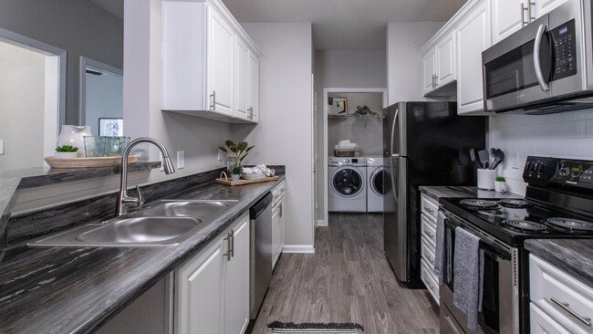 Embrace our charming galley-style kitchens with ample cabinetry and a pantry for optimal storage and organization. - The Everlee