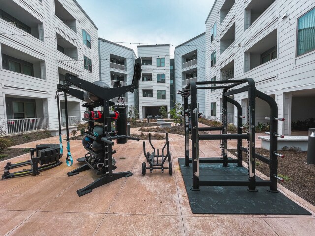 Outside gym with weights, punching bag, squat rack, etc. - 1828 W Pensacola St