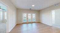 Located at 340 Frontier Way in Sunbury, Ohio, this well-appointed 3-bedroom, 2-bathroom residence offers comfortable single-floor living with a thoughtful, functional layout. Light-toned luxury vinyl plank flooring flows throughout the main living areas and hallways, creating a clean, cohesive aesthetic, while plush carpeting adds warmth to all three bedrooms, each equipped with a ceiling fan.

The open-concept living, dining, and kitchen area serves as the heart of the home. The kitchen features white shaker cabinetry extending to the ceiling, stainless steel appliances including a refrigerator, stove, and microwave, and a large island with a white quartz countertop and pendant lighting above. A dedicated pantry provides additional storage. French doors off the living area open to a private balcony, flooding the space with natural light and offering outdoor views.

The generously sized primary bedroom includes a dedicated closet and access to natural light. The bathrooms are finished with white vanity cabinetry, framed mirrors, and tile-surround walk-in showers. A dedicated laundry area and well-proportioned hallways with additional closets round out this clean, move-in-ready home.