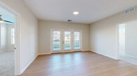 Located at 340 Frontier Way in Sunbury, Ohio, this well-appointed 3-bedroom, 2-bathroom residence offers comfortable single-floor living with a thoughtful, functional layout. Light-toned luxury vinyl plank flooring flows throughout the main living areas and hallways, creating a clean, cohesive aesthetic, while plush carpeting adds warmth to all three bedrooms, each equipped with a ceiling fan.

The open-concept living, dining, and kitchen area serves as the heart of the home. The kitchen features white shaker cabinetry extending to the ceiling, stainless steel appliances including a refrigerator, stove, and microwave, and a large island with a white quartz countertop and pendant lighting above. A dedicated pantry provides additional storage. French doors off the living area open to a private balcony, flooding the space with natural light and offering outdoor views.

The generously sized primary bedroom includes a dedicated closet and access to natural light. The bathrooms are finished with white vanity cabinetry, framed mirrors, and tile-surround walk-in showers. A dedicated laundry area and well-proportioned hallways with additional closets round out this clean, move-in-ready home.
