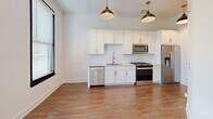 Located at 601 Indian St in the heart of Savannah, GA, this one-bedroom, one-bathroom unit offers a thoughtfully designed layout that maximizes every square foot of its compact footprint. The open-concept kitchen and living area serves as the heart of the space, featuring warm hardwood-style flooring, crisp white cabinetry, a herringbone tile backsplash, and a full suite of stainless steel appliances including a refrigerator with ice maker, electric range, microwave, and dishwasher. Stylish matte black pendant lights hang above, lending a modern industrial touch. A pantry provides additional storage to complement the well-appointed kitchen. The bedroom is an intimate yet functional retreat, highlighted by bold black-framed sliding glass doors that open to a private balcony, flooding the room with natural light and offering leafy outdoor views. Two closets offer ample storage throughout the unit. The bathroom is finished with clean white subway tile in the tub/shower surround, a marble-topped vanity with brushed nickel fixtures, and hardwood-style flooring that ties the space together. A dedicated utility room rounds out the floor plan, adding practical convenience to this well-designed Savannah residence.