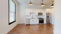 Located at 601 Indian St in the heart of Savannah, GA, this one-bedroom, one-bathroom unit offers a thoughtfully designed layout that maximizes every square foot of its compact footprint. The open-concept kitchen and living area serves as the heart of the space, featuring warm hardwood-style flooring, crisp white cabinetry, a herringbone tile backsplash, and a full suite of stainless steel appliances including a refrigerator with ice maker, electric range, microwave, and dishwasher. Stylish matte black pendant lights hang above, lending a modern industrial touch. A pantry provides additional storage to complement the well-appointed kitchen. The bedroom is an intimate yet functional retreat, highlighted by bold black-framed sliding glass doors that open to a private balcony, flooding the room with natural light and offering leafy outdoor views. Two closets offer ample storage throughout the unit. The bathroom is finished with clean white subway tile in the tub/shower surround, a marble-topped vanity with brushed nickel fixtures, and hardwood-style flooring that ties the space together. A dedicated utility room rounds out the floor plan, adding practical convenience to this well-designed Savannah residence.