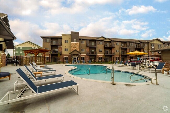 Our resort-style pool area has plenty of seating, perfect for enjoying a relaxing day outdoors. - WH Flats