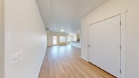 Located at 10602 Burns Rd in Pasco, WA, this well-appointed one-bedroom, one-bathroom unit offers a clean, modern design across a single floor. The open-concept living and kitchen area is bright and airy, featuring light wood-style flooring, white walls, and large windows that invite natural light and provide views of the surrounding neighborhood. A private entry door adds convenience and a sense of independence.

The kitchen is thoughtfully designed with light wood cabinetry, a sleek quartz-style countertop island with a double sink, and a full suite of stainless steel appliances including a refrigerator, electric range, microwave, and dishwasher. Track lighting overhead highlights the functional and stylish workspace.

The spacious bedroom is carpeted for comfort, includes a wall-mounted mini-split heating and cooling unit for year-round climate control, and features a window with outdoor views. The bathroom offers a full tub-shower combination with clean white surrounds. A dedicated laundry room houses a full-size Whirlpool washer and dryer with overhead wire shelving for added storage. A closet provides additional organization space, completing this efficient and modern single-level layout.
