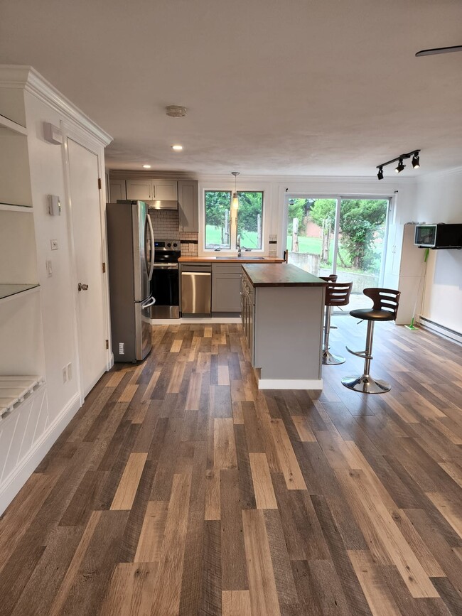 Beautifully updated kitchen with warm butcher block countertops & stainless steel kitchen appliances - 3 Annanias Ave
