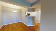 Located at 190 112th Ave N in Saint Petersburg, Florida, this single-floor residence offers a well-designed layout with a cohesive blend of comfort and functionality. The spacious living room is a standout feature, showcasing rich, dark hardwood flooring, neutral-toned walls, and a textured ceiling. French doors invite abundant natural light and provide outdoor access, enhancing the open and airy feel of the space. An adjacent dining area connects seamlessly to the kitchen via a pass-through breakfast bar, accented by a stylish pendant light overhead. The kitchen is well-appointed with white cabinetry, white quartz-style countertops, a gray subway tile backsplash, and a full suite of stainless steel appliances including a range, microwave, and dishwasher. The bedrooms offer plush carpeting, textured ceilings, and ample natural light through blinds-fitted windows, with the primary bedroom including a ceiling fan. The bathroom features wood-look flooring, a tub-shower combination, and a white vanity. Throughout the home, a consistent neutral color palette and warm wood flooring create a cohesive and inviting atmosphere suited for everyday living.