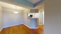 Located at 190 112th Ave N in Saint Petersburg, Florida, this single-floor residence offers a well-designed layout with a cohesive blend of comfort and functionality. The spacious living room is a standout feature, showcasing rich, dark hardwood flooring, neutral-toned walls, and a textured ceiling. French doors invite abundant natural light and provide outdoor access, enhancing the open and airy feel of the space. An adjacent dining area connects seamlessly to the kitchen via a pass-through breakfast bar, accented by a stylish pendant light overhead. The kitchen is well-appointed with white cabinetry, white quartz-style countertops, a gray subway tile backsplash, and a full suite of stainless steel appliances including a range, microwave, and dishwasher. The bedrooms offer plush carpeting, textured ceilings, and ample natural light through blinds-fitted windows, with the primary bedroom including a ceiling fan. The bathroom features wood-look flooring, a tub-shower combination, and a white vanity. Throughout the home, a consistent neutral color palette and warm wood flooring create a cohesive and inviting atmosphere suited for everyday living.