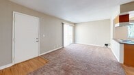 Located at 555 E Bonita Ave in San Dimas, CA, this efficiently designed one-bedroom, one-bathroom residence offers a comfortable and functional single-floor layout. The open-concept great room seamlessly combines the living, dining, and kitchen areas, creating an inviting and versatile space. Warm-toned carpet flows through the living area, transitioning to hardwood-style flooring that runs through the kitchen and entryway. A sliding glass door floods the living room with natural light and opens to a private balcony, perfect for enjoying the Southern California climate. The kitchen is well-appointed with rich wood cabinetry, granite countertops, a tray ceiling with recessed lighting, and a window that brings in additional natural light. Ceiling fans in both the living area and bedroom provide year-round comfort. The spacious bedroom features soft carpeting, a generous closet, and its own ceiling fan. The full bathroom echoes the kitchen's design with matching wood cabinetry and granite countertops, complemented by a tub-shower combination. Two closets provide ample storage throughout the home, and a dedicated hallway connects all areas of the residence efficiently.