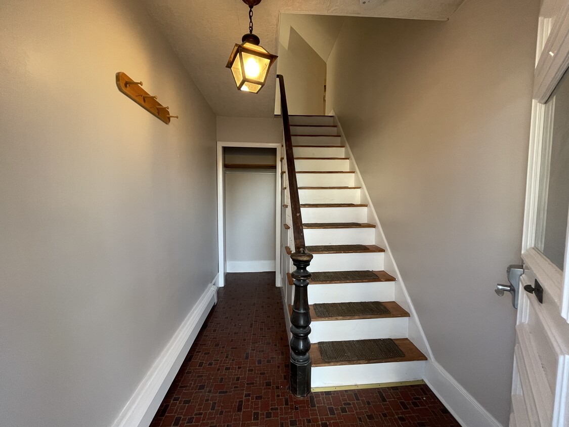 Private entrance with mud room and staircase leading up to apartment - 19 Cottage St