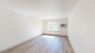 Located at 1240 Oak Terrace Dr in Traverse City, MI, this one-bedroom, one-bathroom unit offers a well-organized, single-floor layout designed for comfortable, efficient living. Light wood-style flooring runs throughout the space, lending a clean and cohesive look to every room.

The combined kitchen and living area serves as the heart of the unit. The galley-style kitchen is outfitted with warm oak cabinetry, light countertops, a double-basin sink, a white electric range, and a full-size refrigerator — providing ample storage and functional workspace. A peninsula counter separates the kitchen from the entry, creating a natural transition into the living area, which receives generous natural light through a large window overlooking a wooded landscape.

The bedroom is a comfortable, private retreat featuring a built-in double closet with bi-fold doors and a window that frames lush, tree-lined views. Baseboard heating runs along the perimeter, ensuring year-round comfort.

The bathroom is thoughtfully equipped with accessibility in mind, including multiple grab bars, a full-sized tub/shower combo, and a wood-toned vanity with a light countertop. Light-toned walls and wood-style flooring maintain a clean, consistent aesthetic throughout.