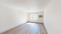 Located at 1240 Oak Terrace Dr in Traverse City, MI, this one-bedroom, one-bathroom unit offers a well-organized, single-floor layout designed for comfortable, efficient living. Light wood-style flooring runs throughout the space, lending a clean and cohesive look to every room.

The combined kitchen and living area serves as the heart of the unit. The galley-style kitchen is outfitted with warm oak cabinetry, light countertops, a double-basin sink, a white electric range, and a full-size refrigerator — providing ample storage and functional workspace. A peninsula counter separates the kitchen from the entry, creating a natural transition into the living area, which receives generous natural light through a large window overlooking a wooded landscape.

The bedroom is a comfortable, private retreat featuring a built-in double closet with bi-fold doors and a window that frames lush, tree-lined views. Baseboard heating runs along the perimeter, ensuring year-round comfort.

The bathroom is thoughtfully equipped with accessibility in mind, including multiple grab bars, a full-sized tub/shower combo, and a wood-toned vanity with a light countertop. Light-toned walls and wood-style flooring maintain a clean, consistent aesthetic throughout.
