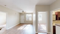 This single-floor residence is designed with a practical, open layout that connects the living area directly to the kitchen, creating a cohesive and functional flow throughout the space. The living area features wood-style laminate flooring, neutral beige walls, and a ceiling fan with integrated lighting. Multiple windows allow generous natural light to fill the room, contributing to a bright and welcoming atmosphere. The front entry door is conveniently located within the living space.

The galley-style kitchen is well-appointed with rich dark wood cabinetry, light granite-style countertops, and a full suite of stainless steel appliances including a refrigerator, electric range, microwave, and dishwasher. A stainless steel sink and additional pantry or storage closet complete the kitchen's functional design.

The bedrooms feature plush carpeting and neutral walls, with each room benefiting from natural light through standard windows. Closet space is generously provided, including a walk-in closet with wire shelving systems and additional reach-in closets with hanging rods.

Both bathrooms are consistently finished with dark wood vanity cabinetry, light countertops, wood-style flooring, and full tub-shower combinations, offering a clean and cohesive aesthetic throughout.