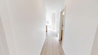 Located in the desirable SW Calgary neighbourhood of Marda Loop, this thoughtfully designed 3-bedroom, 2-bathroom unit offers a clean, contemporary aesthetic throughout. Light-toned laminate flooring flows seamlessly across the single-level layout, complemented by crisp white walls that maximize the brightness in every room.

The open-concept kitchen is a standout feature, showcasing warm natural wood cabinetry, white quartz countertops, stainless steel appliances including a refrigerator, electric range, and microwave, plus a large peninsula with an integrated sink — ideal for both cooking and casual entertaining. A modern pendant light fixture adds a stylish focal point overhead.

The living area is generously illuminated by oversized grid-pane windows that frame views of the surrounding Calgary neighbourhood, flooding the space with natural light. Each bedroom maintains the same bright, airy feel, with the primary bedroom benefiting from a dedicated walk-in closet with built-in shelving.

Both bathrooms are finished in a clean, modern style — one featuring a glass-enclosed shower and the other a full soaker tub with tiled surround. A well-proportioned hallway connects all rooms efficiently. The overall ambiance is fresh, minimalist, and move-in ready.