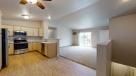 Located at 713 Horicon St in Horicon, Wisconsin, this single-floor unit offers a practical and well-appointed layout designed for comfortable everyday living. The open-concept main living area seamlessly connects the kitchen and living room, creating a bright, airy feel enhanced by a ceiling fan and a sliding glass door that fills the space with natural light and provides access to an outdoor patio. The transition from hardwood-style flooring in the kitchen to plush carpeting in the living area adds visual warmth and definition to the shared space.

The kitchen is equipped with light wood cabinetry, stainless steel appliances including a range, over-the-range microwave, and dishwasher, along with light-toned countertops and a double sink — offering both functionality and a clean, cohesive aesthetic.

Two carpeted bedrooms each feature windows that bring in natural light, individual climate control units, and baseboard heating. The primary bathroom includes a wide vanity with ample cabinet storage, a large mirror, and hardwood-style flooring. A second full bathroom features a walk-in shower stall. A dedicated laundry room with a full-size washer and dryer rounds out this thoughtfully designed unit.