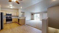 Located at 713 Horicon St in Horicon, Wisconsin, this single-floor unit offers a practical and well-appointed layout designed for comfortable everyday living. The open-concept main living area seamlessly connects the kitchen and living room, creating a bright, airy feel enhanced by a ceiling fan and a sliding glass door that fills the space with natural light and provides access to an outdoor patio. The transition from hardwood-style flooring in the kitchen to plush carpeting in the living area adds visual warmth and definition to the shared space.

The kitchen is equipped with light wood cabinetry, stainless steel appliances including a range, over-the-range microwave, and dishwasher, along with light-toned countertops and a double sink — offering both functionality and a clean, cohesive aesthetic.

Two carpeted bedrooms each feature windows that bring in natural light, individual climate control units, and baseboard heating. The primary bathroom includes a wide vanity with ample cabinet storage, a large mirror, and hardwood-style flooring. A second full bathroom features a walk-in shower stall. A dedicated laundry room with a full-size washer and dryer rounds out this thoughtfully designed unit.