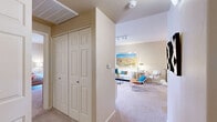 Located in Oro Valley, AZ, this two-bedroom, two-bathroom single-floor residence offers a thoughtfully designed layout with comfortable living spaces throughout. The living room is bright and welcoming, featuring track lighting, plush carpeting, and sliding glass doors that open to a private patio with lush outdoor views — ideal for enjoying Arizona's natural surroundings. The kitchen is well-equipped with warm honey-toned cabinetry, granite-style countertops, a peninsula breakfast bar, hardwood-style flooring, and a distinctive tray ceiling with a skylight that fills the space with natural light. The primary bedroom is generously sized, complete with a ceiling fan, carpeted flooring, and direct access to a spacious walk-in closet featuring multi-tier wire shelving. Its en-suite bathroom includes a walk-in shower with tile accents and a single-sink vanity. The second bedroom also features a ceiling fan and ample natural light. The second bathroom offers a full soaking tub and shower combo with tile surround and a wood-framed vanity. A hallway with a large double-door closet provides additional storage. Warm neutral tones and consistent finishes create a cohesive, comfortable ambiance throughout the home.